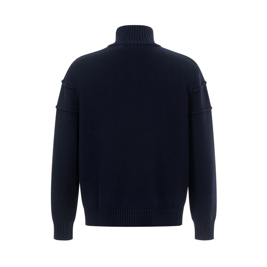 Dark blue turtleneck sweater on a light gray background